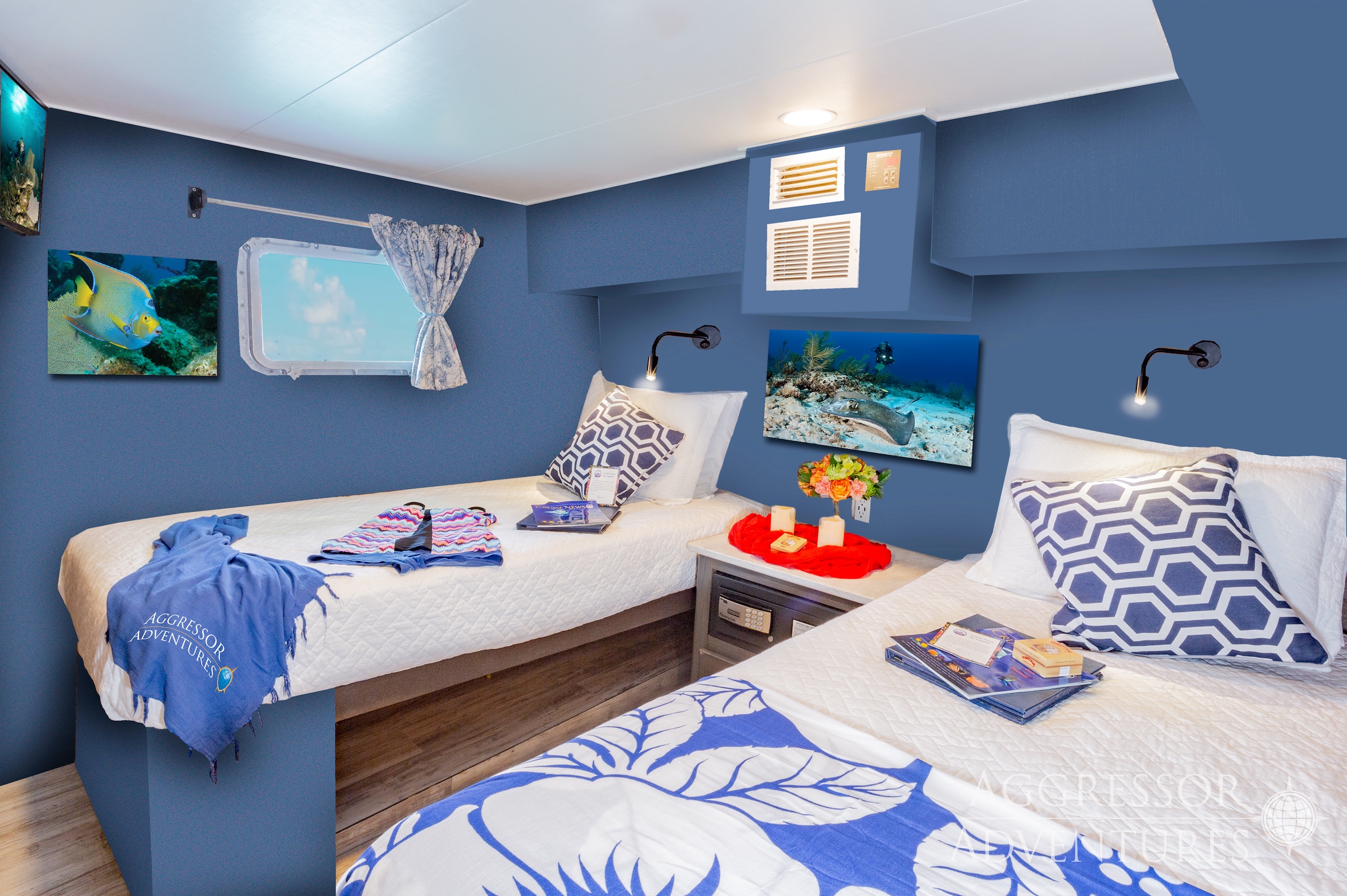 Comfortable deluxe stateroom with twin beds and large window on Cayman Aggressor IV