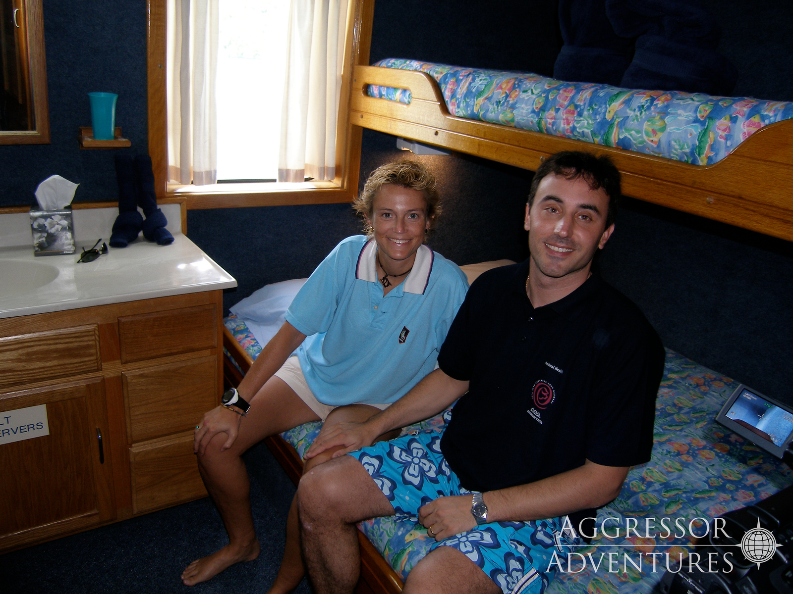 deluxe stateroom with queen bed and large window on Palau Aggressor II