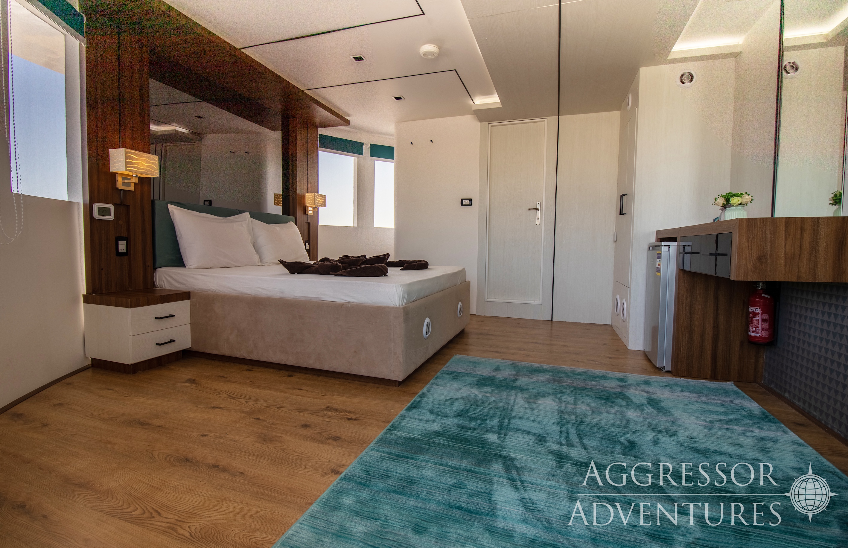Luxury master suite stateroom with queen bed and panoramic windows aboard Red Sea Aggressor IV