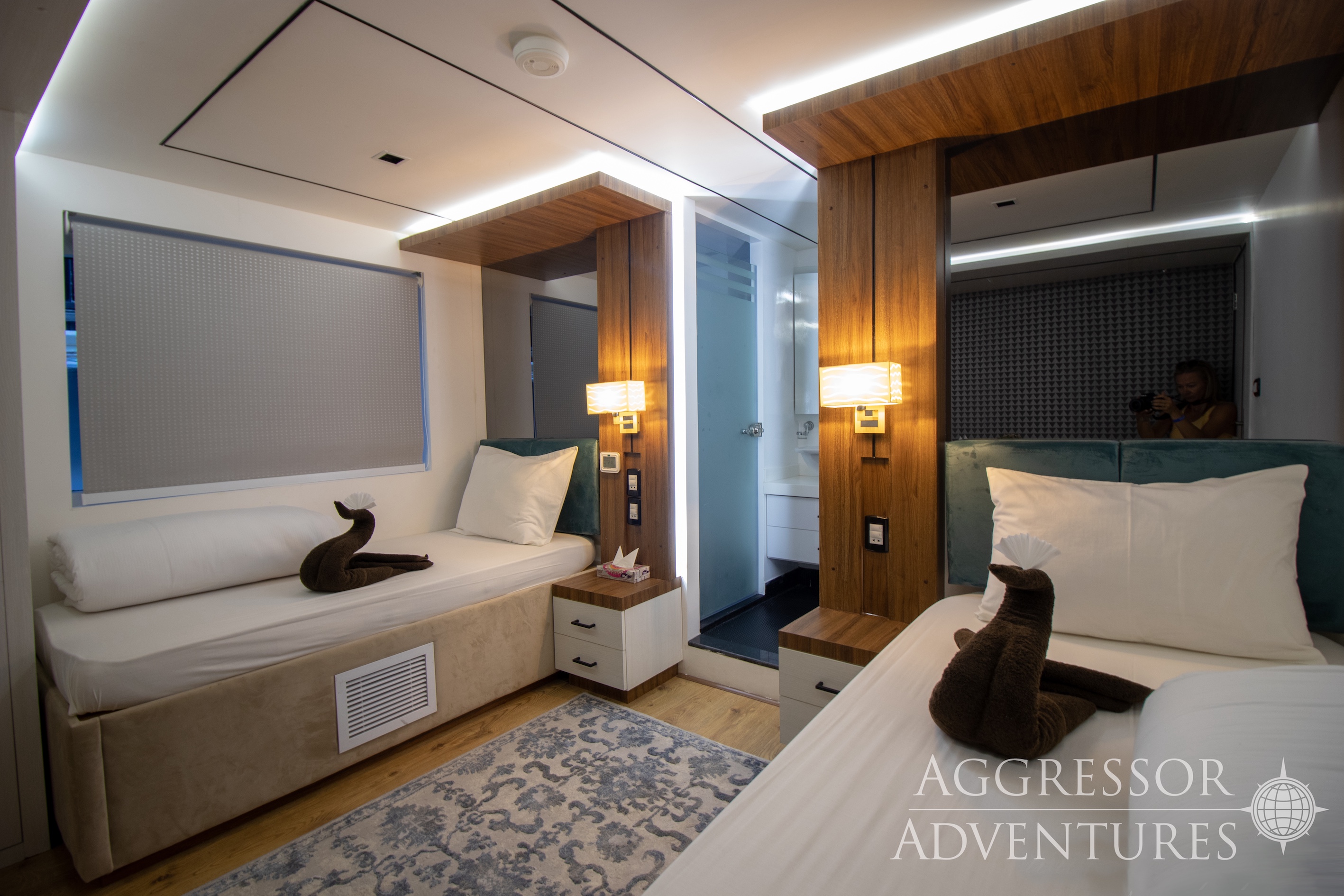 Comfortable twin stateroom with two single beds and porthole windows on Red Sea Aggressor IV