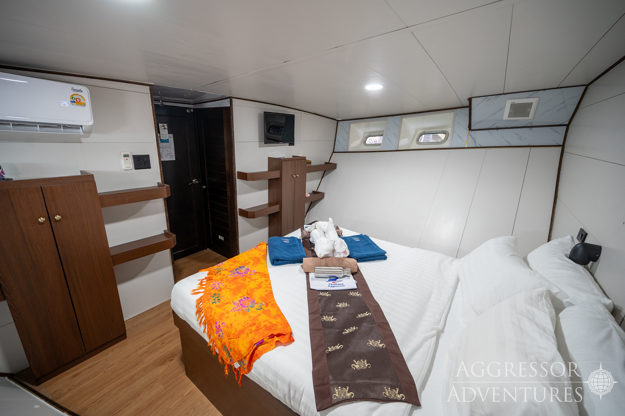 Spacious deluxe stateroom with convertible king or queen bed and picture window on Thailand Aggressor